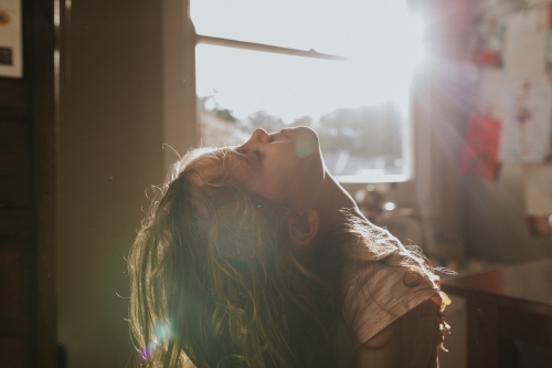 Young girl enjoying the sun on her face - Australian Stock Image
