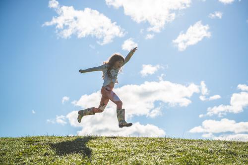 Young girl leaping - Australian Stock Image