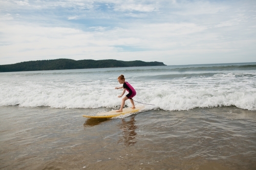 Young girl learning to surf - Australian Stock Image