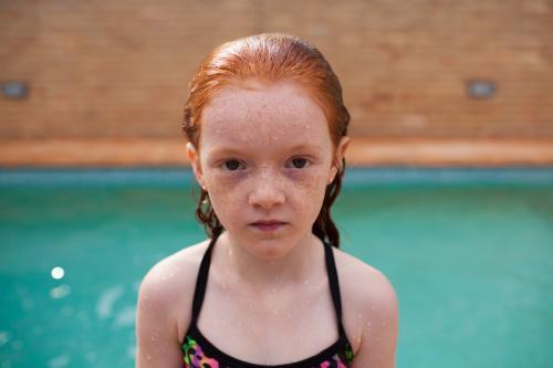 Young girl looking serious after a swim - Australian Stock Image