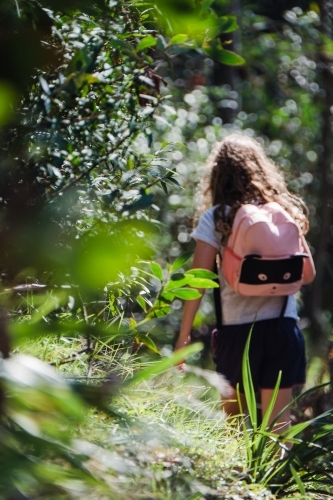 Young girl on a hike with her backpack on. - Australian Stock Image