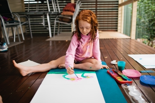 Young girl painting a picture - Australian Stock Image
