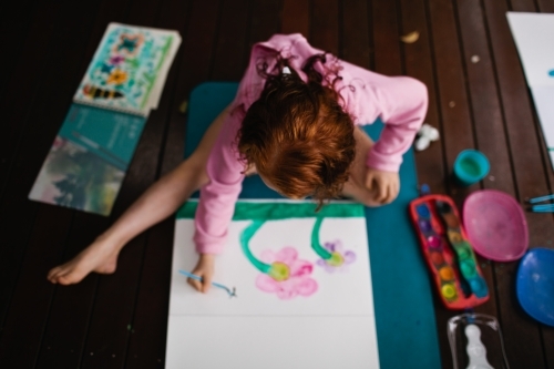 Young girl painting a picture - Australian Stock Image