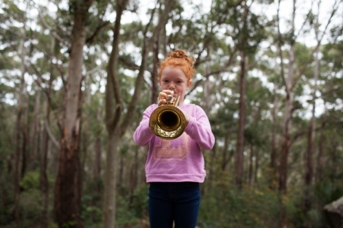 Young girl playing a trumpet - Australian Stock Image