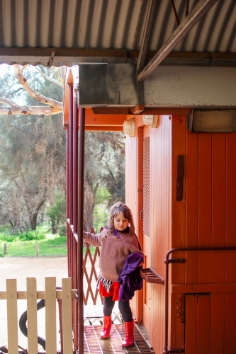 Young girl playing on a vintage train