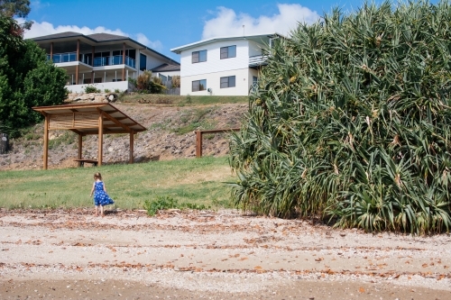 Young girl playing on beach - Australian Stock Image