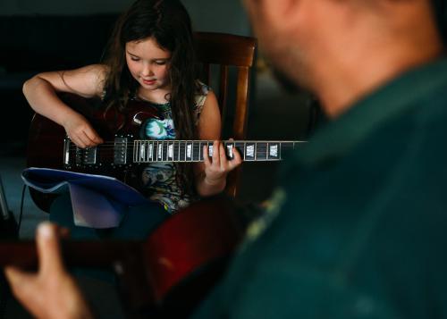 Young girl practising guitar
