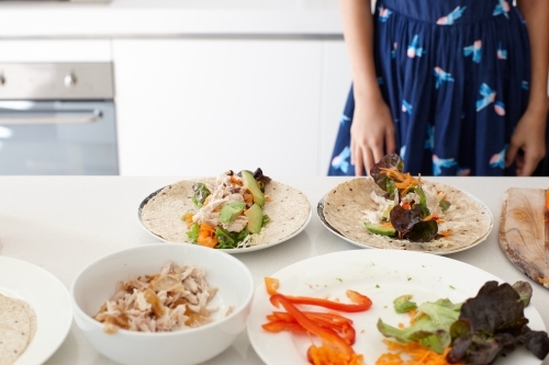 Young girl preparing healthy lunch in kitchen - Australian Stock Image