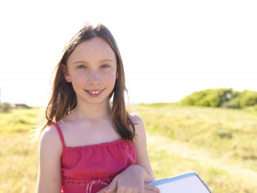 Young girl preparing to go body boarding - Australian Stock Image