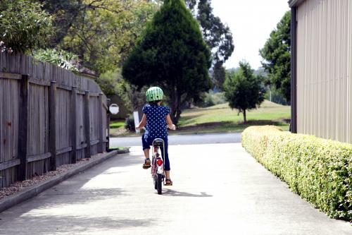 Young girl riding bike - Australian Stock Image