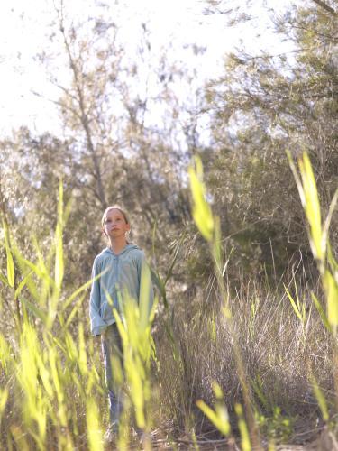 Young girl standing in the bush - Australian Stock Image