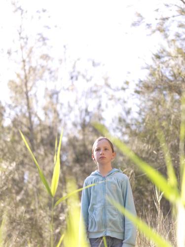 Young girl standing in the bush - Australian Stock Image