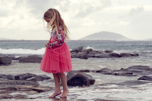 Young girl walking on beach - Australian Stock Image