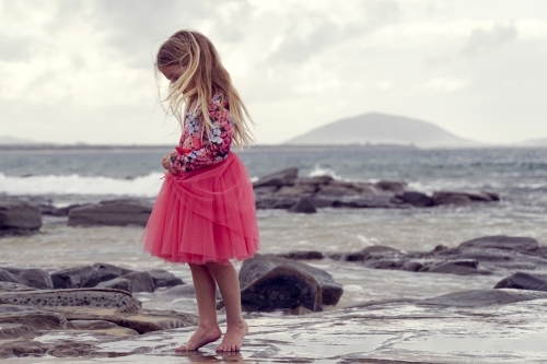Young girl walking on beach