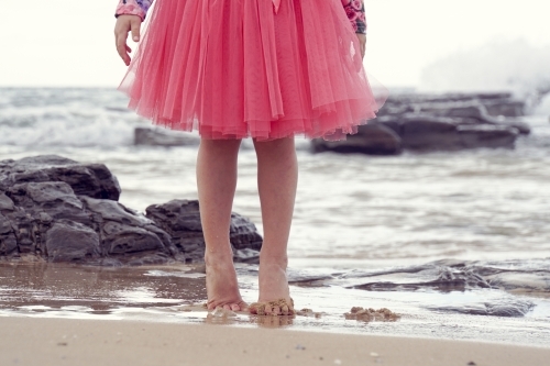 Young girl walking on beach - Australian Stock Image