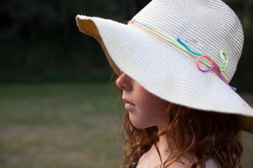 Young girl wearing a floppy hat