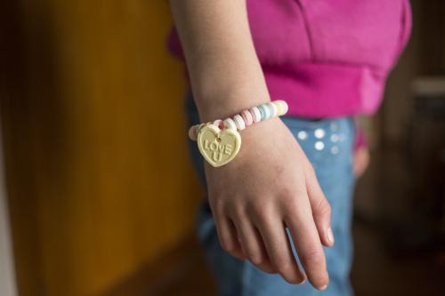 Young girl wearing candy bracelet hand only