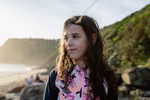 Young girl with a sand speckled face on the beach at sunset; Bushrangers Bay, Cape Schanck