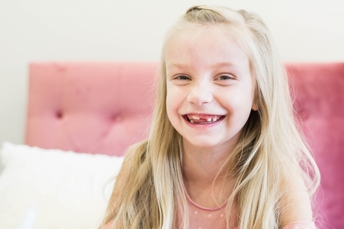 Young girl with long blonde hair smiling - Australian Stock Image