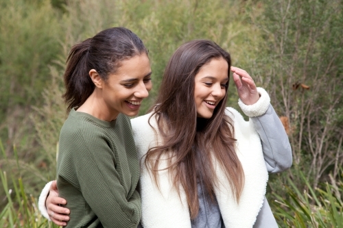 Young happy female friends walking in the bush - Australian Stock Image