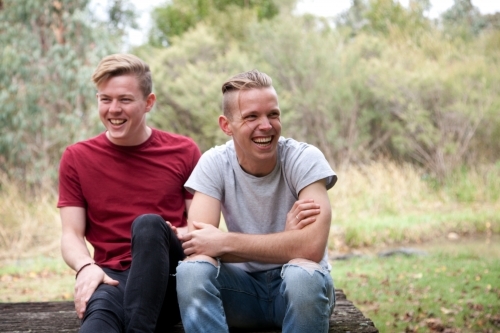 Young happy male same sex couple in a rural setting - Australian Stock Image