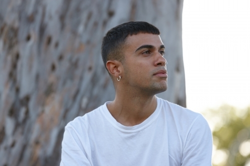 Young Indigenous Australian man enjoying time outdoors - Australian Stock Image