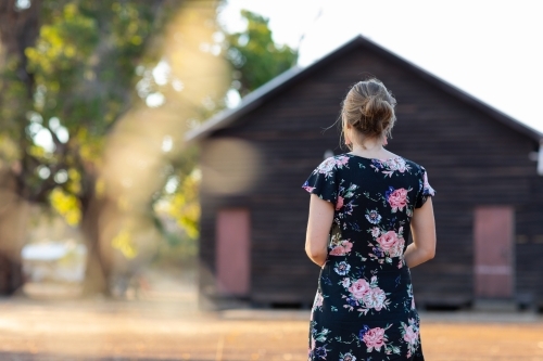 young lady from behind in front of country hall - Australian Stock Image