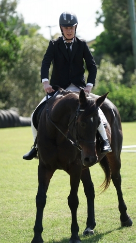 Young man competing in horse competition
