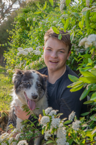 Young man holding his dog - Australian Stock Image