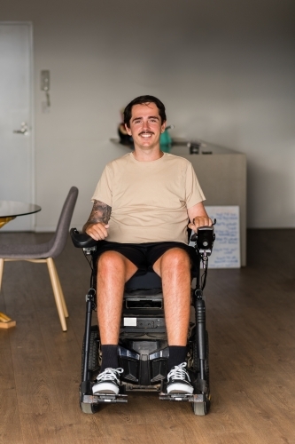 young man in motorised wheelchair - Australian Stock Image