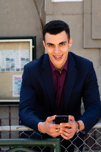 young man using mobile phone - Australian Stock Image