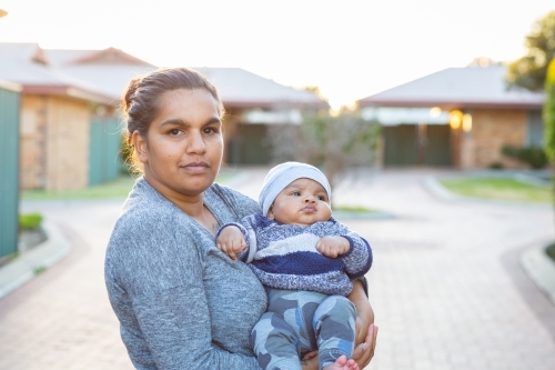 Young mother holding her baby outside - Australian Stock Image