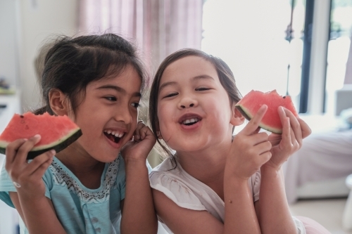 Young multicultural girls having watermelon in summer - Australian Stock Image