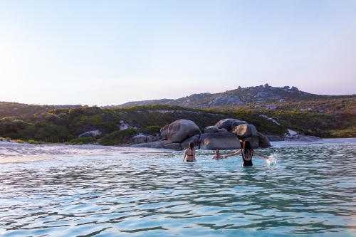 young people enjoying themselves in calm water at Bettys Beach - Australian Stock Image
