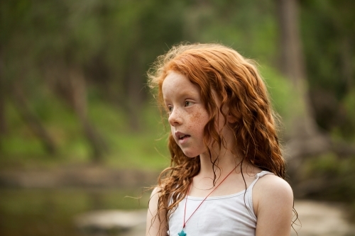 Young redhead girl by the riverside - Australian Stock Image