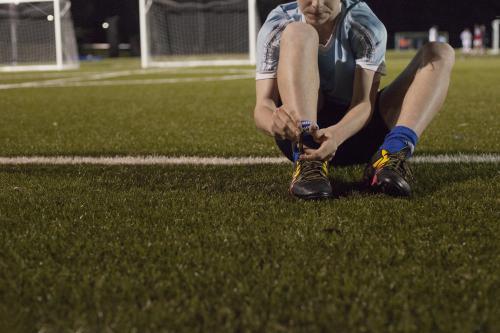 Young teen boy preparing to do evening soccer training