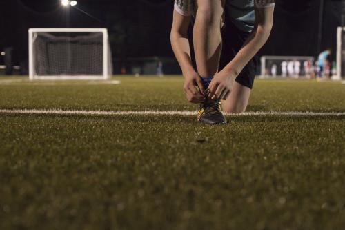 Young teen boy preparing to do evening soccer training