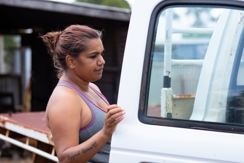 young woman at drivers door of white ute - Australian Stock Image