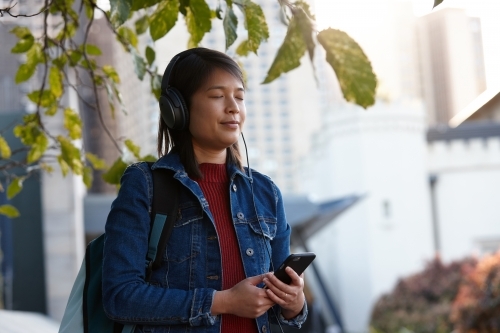 Young woman closing eyes listening to music - Australian Stock Image