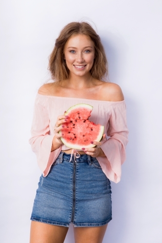 young woman eating watermelon - Australian Stock Image