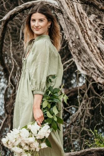 Young woman holds bunch of roses - Australian Stock Image