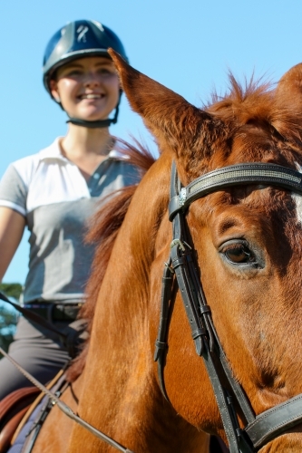 Young woman horse riding in park - Australian Stock Image