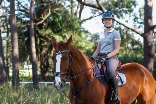 Young woman horse riding in park