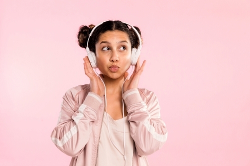 young woman, listening to music on headphones & dancing. - Australian Stock Image
