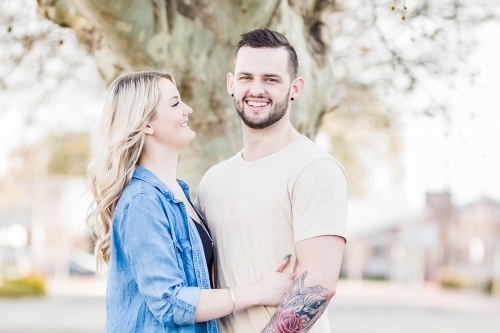 Young woman looking at boyfriend laughing - Australian Stock Image