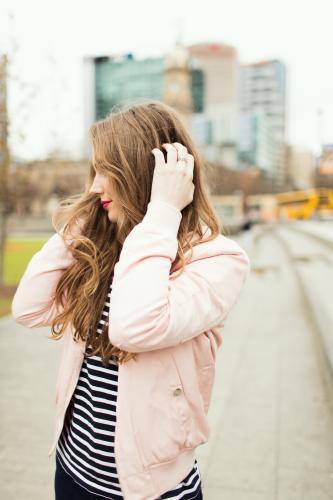 Young woman posing and smiling in the city - Australian Stock Image