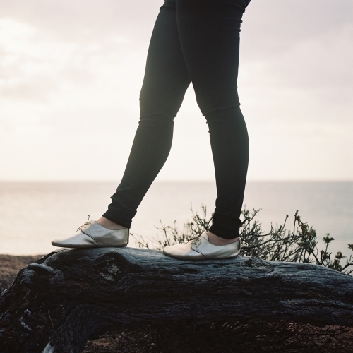 Young Woman Standing on Log - Australian Stock Image