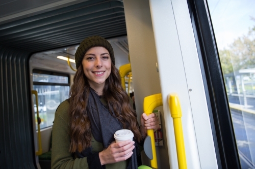 Young Woman Standing on the Tram - Australian Stock Image