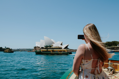 young woman taking photos of Sydney Harbour - Australian Stock Image