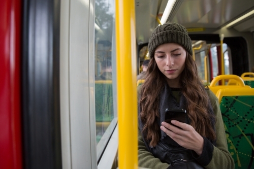 Young Woman Texting on the Tram